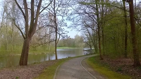 POV Walking Along the Lake Path in Rheinaue Park, Bonn Stockbeeldmateriaal 336219491