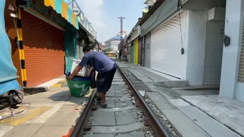 POV walking along train track daytime Maeklong Umbrella Market Stock Footage 196267487