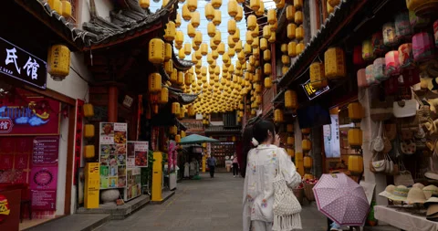 POV walking at Dali Old Town street decorated with yellow lanterns Vidéo 329461670
