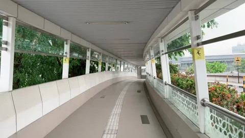 Pov walking in Enclosed Elevated Pedestrian Skywalk without people Stock Footage 343476015