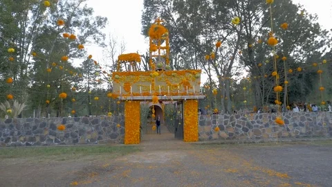 POV walking into the entrance of a cemetery decorated for the Day of the Dead Stock Footage