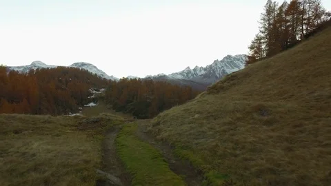 POV walking on fall field path near lake with snowy mounts.Evening autumn day 動画素材 80090533