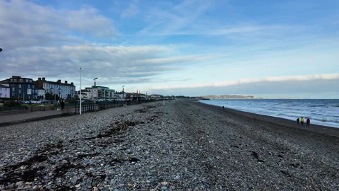 POV walking forward along a pebble beach parallel to the sea Stock Footage 345176922