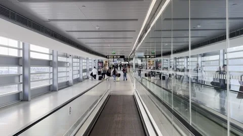 POV walking on a moving walkway inside an airport terminal Stock Footage 319784767