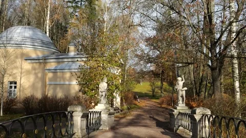 POV walking over Centaurs Bridge with marble statues in Pavlovsk Park, Russia Stock Footage 321186773