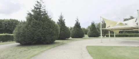 Pov of walking a path towards a gazebo - HLG footage Video stock 196113386