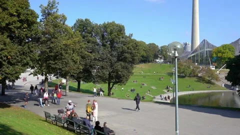 POV walking on paved footpath in Olympiapark (Olympic Park) in Munich Stock Footage 170898562