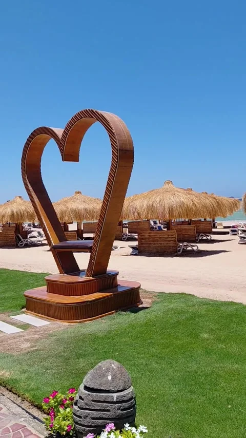 POV walking on sandy resort beach with thatched umbrellas in Sahl Hasheesh. Stock Footage 337532727