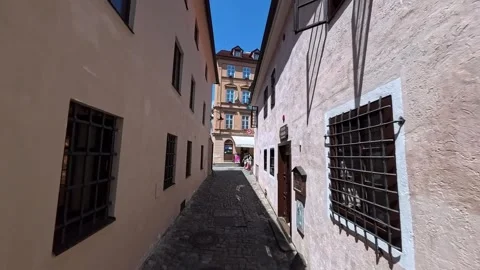 POV walking shot through narrow cobblestone streets of Cesky Krumlov 27.06.2026 Stock Footage 341466339