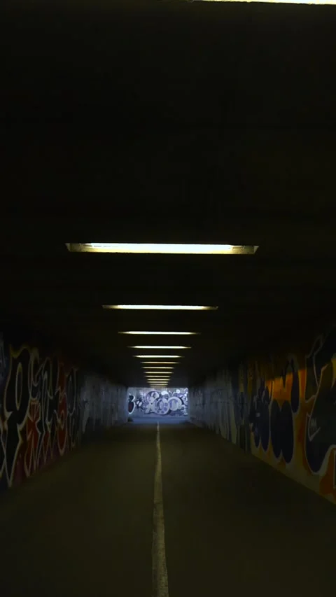 Pov walking through a dark empty underground graffiti tunnel Stock Footage 346736902