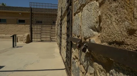 POV walking through a prison cell block in hot sun Stock Footage 61943838