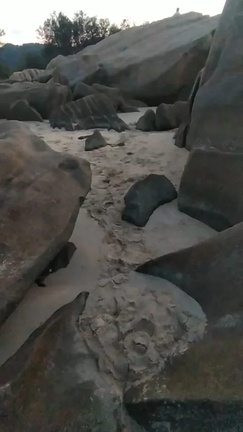 POV Walking Through Rocky Beach 4K Stock Footage 335939097