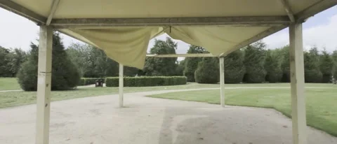 Pov of walking under a torn yellow gazebo - HLG footage Video stock 196113376