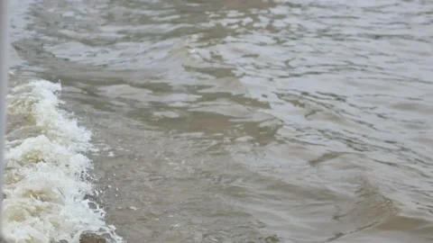 POV to the water surface with waves while on the boat in the river Stock Footage 165404768