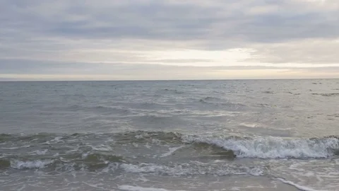 POV waves rolling in to the beach Stock Footage 82383809