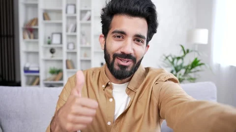 POV. Webcam view. Young handsome man talking on a video call using a smartphone  Stock Footage 252213336