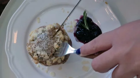 POV while cutting blueberry muffin Stock Footage 165404978