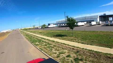 POV while driving a red Jeep past cold storage warehouse for perishable Vídeos de archivo 157091036