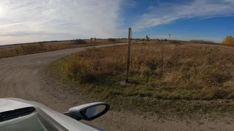 POV while driving through a national park with dry brown grass and a blue sky Stock Footage 336506841