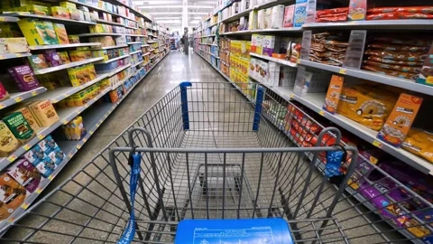 POV while pushing a cart through Walmart past breakfast bars, cereal, and Stock Footage 217359731