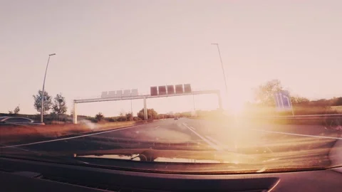 Pov wide angle from the inside of a car on the highway at sunset. Warm light  Stock Footage 151868616