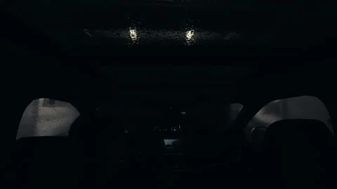 POV wide shot of Driver inside vehicle entering automatic car wash with visible Stock Footage 332183568