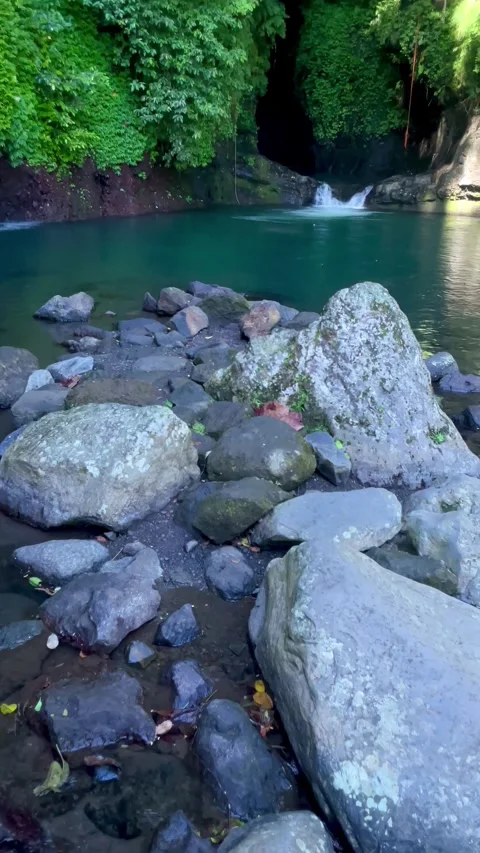 POV wide shot of exploring a rocky river and hidden canyon lagoon in Bali Stock Footage 336904304