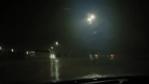 POV wide view of Heavy storm rain in a parking lot out the street lights at Stock Footage 272976101
