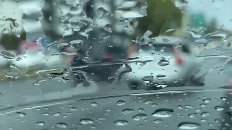 POV Window of Car Rain drops of Anonymous Cars Driving on Public Street Stock Footage 282549817