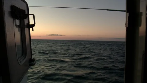 POV from window to sea waves during sunset, Newfoundland, Canada Stock Footage 132398246