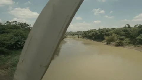 POV from the window of a train that crosses the bridge. Flat color profile. Stock Footage 152981436