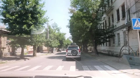 POV Windshield View of SUV Driving Through Town Street in Off Road Expedition Stock Footage 338277855