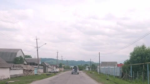 POV Windshield View of SUV Driving Through Rural Village Street Stock Footage 338277861