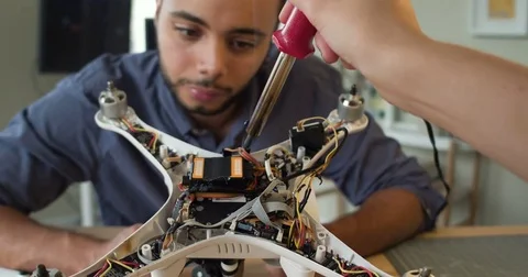 POV Woman's hands welding drone with African American man Stock Footage 80317400