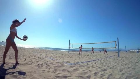 POV of women players playing beach volleyball and serving, slow motion. Stock Footage