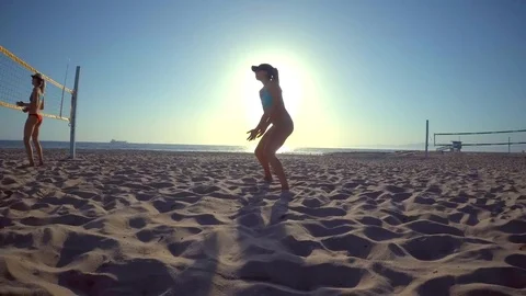 POV of women players playing beach volleyball with a girl diving to dig a ball Stock Footage