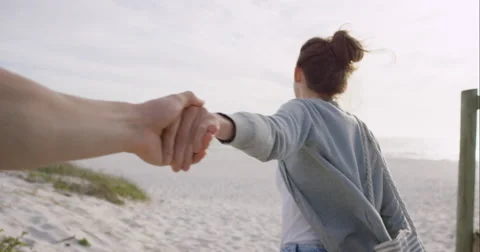 POV of Young couple holding hands woman leading boyfriends walking towards Stock Footage