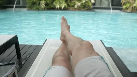 POV to young male's feet while laydown for rest and relaxation on bench day.. Stock Footage 286309538