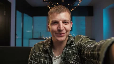 Pov of Young Man make video call using smartphone at home. Guy doing online Stock Footage 225656397