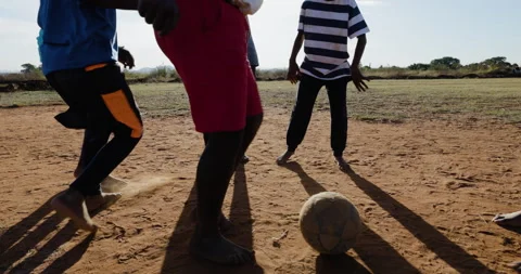 Poverty. Cropped view.  Poor Black African children playing soccer in a township Vídeo Stock 242501916