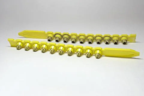 Powder actuated tool loads. spent and new cartridges, inserted into pair of.. Stock Photos