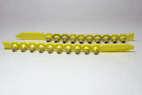 Powder actuated tool loads. spent and new cartridges, inserted into pair of.. Stock Photos