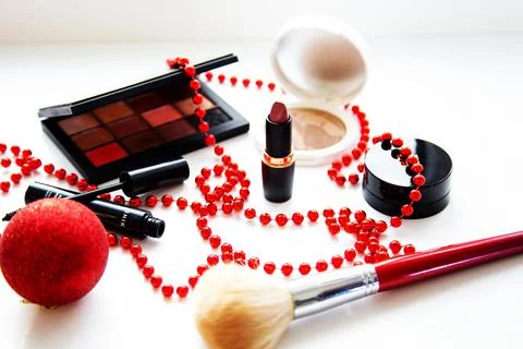 Powder and bronzer, eye shadow, lipstick, blush and brush of different brand Stock Photos