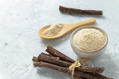 Powder and licorice root on the table - Glycyrrhiza glabra Stock Photos
