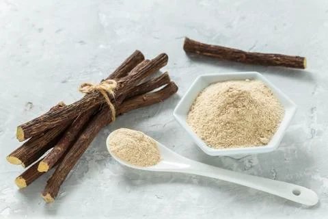 Powder and licorice root on the table - Glycyrrhiza glabra Stock Photos