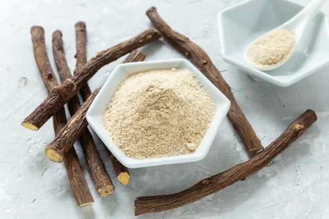 Powder and licorice root on the table - Glycyrrhiza glabra Stock Photos