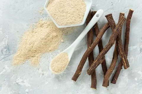 Powder and licorice root on the table - Glycyrrhiza glabra Stock Photos