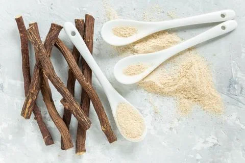 Powder and licorice root on the table - Glycyrrhiza glabra Stock Photos