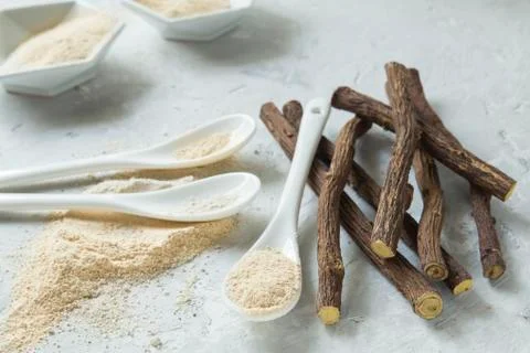 Powder and licorice root on the table - Glycyrrhiza glabra Stock Photos