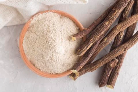 Powder and licorice root on the table - Glycyrrhiza glabra Stock Photos